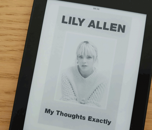 a kindle with the cover of the book My Thoughts Exactly by Lily Allen with a photo of Lily Allen over a wooden texture