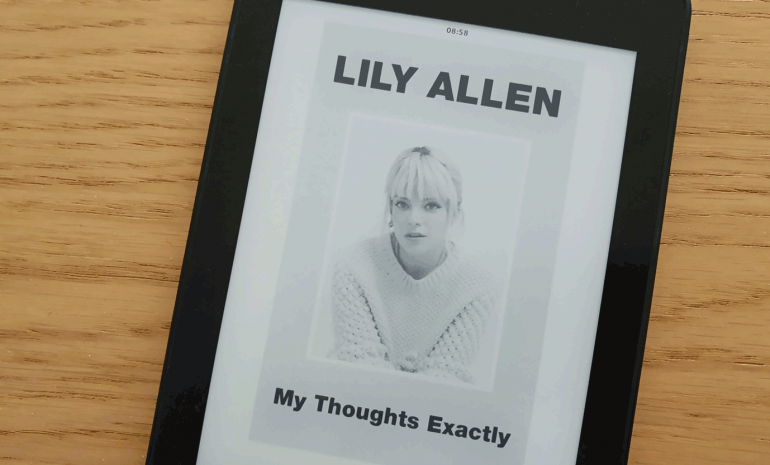 a kindle with the cover of the book My Thoughts Exactly by Lily Allen with a photo of Lily Allen over a wooden texture